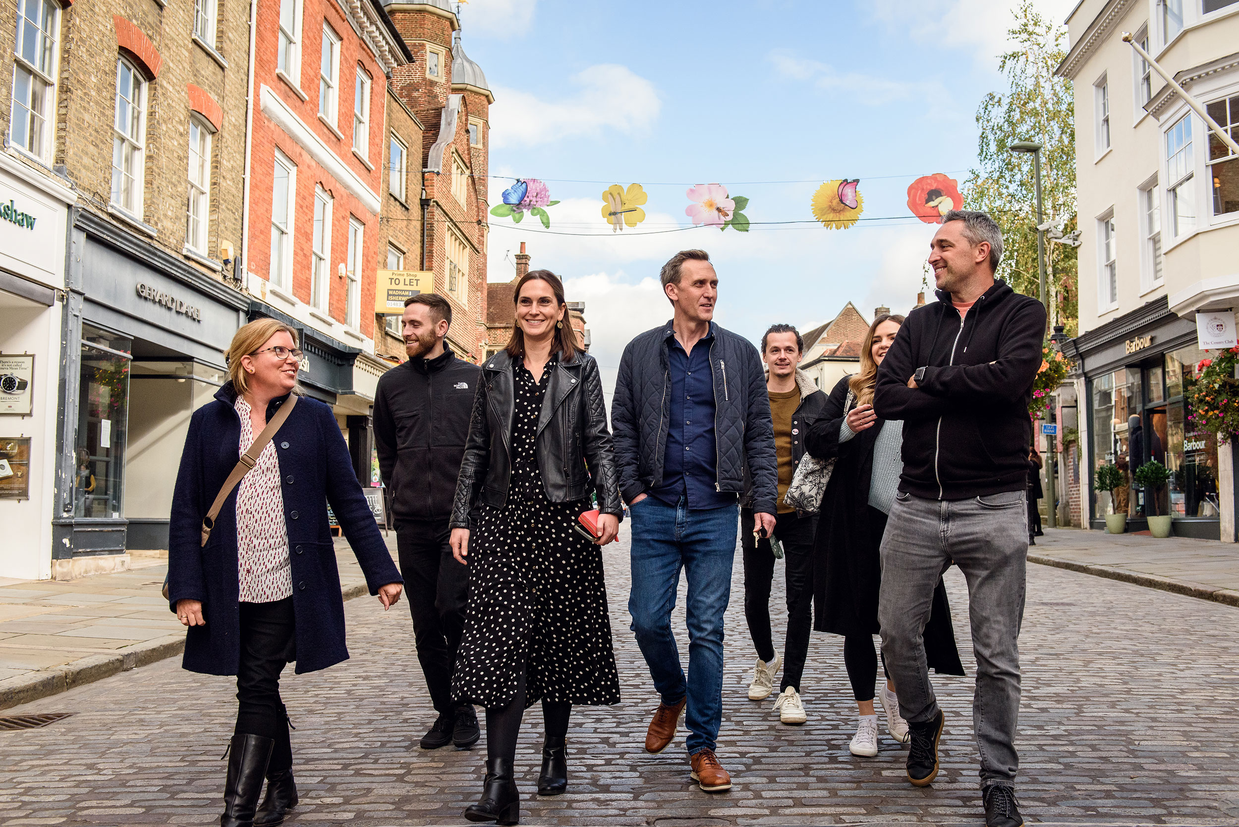 The Orangery team walking down the cobbled high street of Guildford
